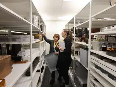 Oil Museum of Canada staff review artifact placement in the collection storage centre.